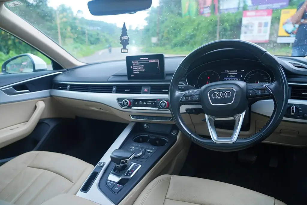 Luxurious seating and dashboard interior of a white Audi A6 sedan in Kollam.