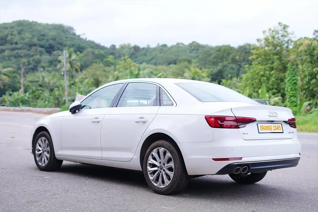 Side profile of a premium white Audi A6 sedan available for rent at Orange Cars in Kollam.