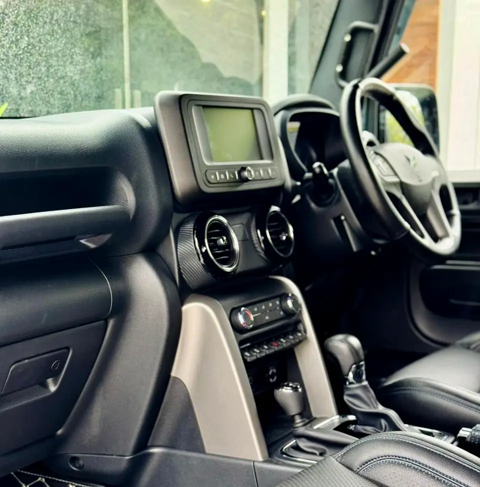 Front cabin and dashboard interior of a Mahindra Thar SUV available for rent in Kollam.
