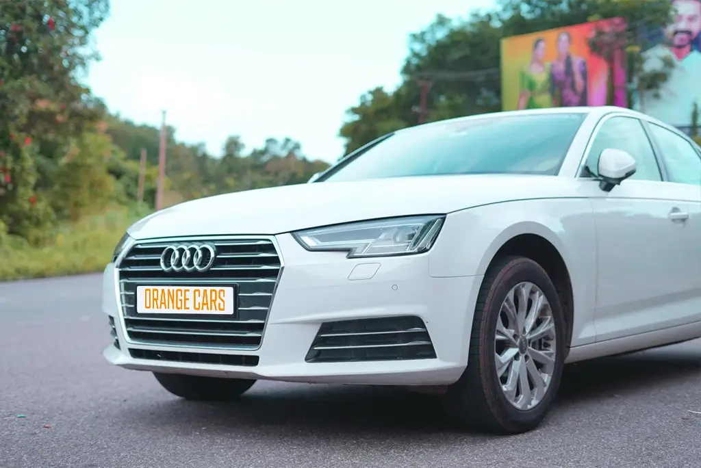 Front view of a white Audi A6 luxury sedan from Orange Cars, ready for wedding rentals in Kollam.
